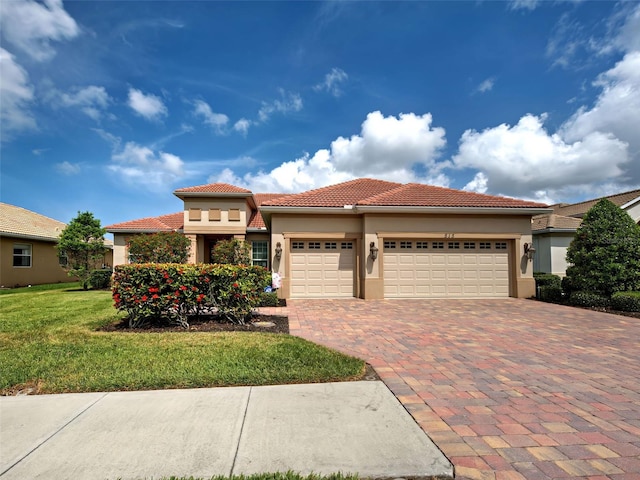 515 Sawgrass Bridge Rd, Venice, FL 34292 - view of front of home with an attached garage, stucco siding, decorative driveway, and a tiled roof