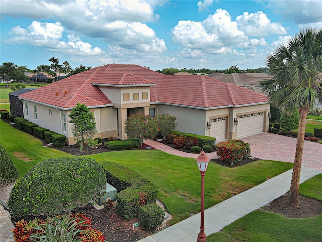 515 Sawgrass Bridge Rd, Venice, FL 34292 - mediterranean / spanish home featuring an attached garage, stucco siding, a front yard, and a tile roof
