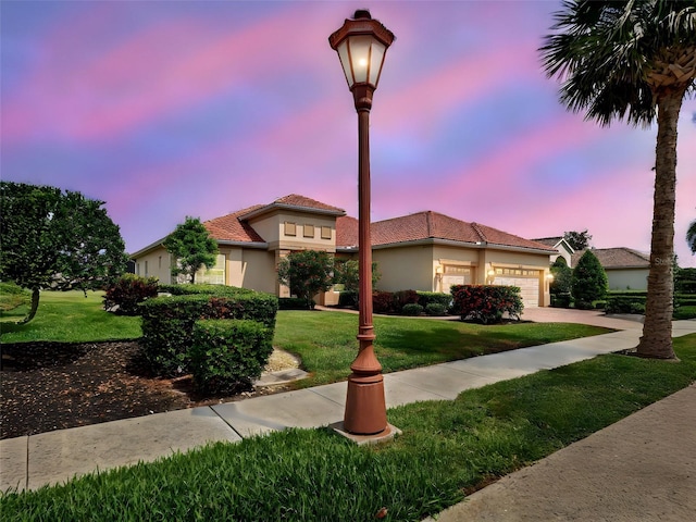 515 Sawgrass Bridge Rd, Venice, FL 34292 - view of front of property featuring a garage, a front yard, stucco siding, and concrete driveway