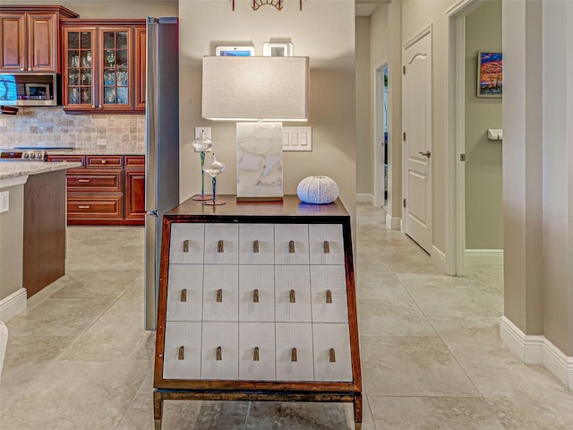515 Sawgrass Bridge Rd, Venice, FL 34292 - kitchen featuring appliances with stainless steel finishes, decorative backsplash, glass insert cabinets, baseboards, and dark brown cabinets