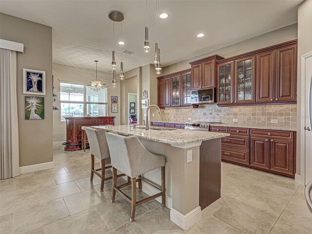 515 Sawgrass Bridge Rd, Venice, FL 34292 - kitchen featuring a sink, stainless steel appliances, a breakfast bar, backsplash, and recessed lighting