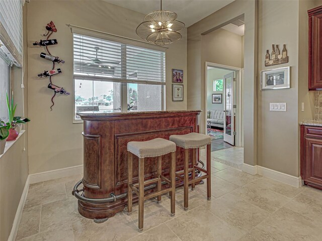 515 Sawgrass Bridge Rd, Venice, FL 34292 - indoor dry bar featuring baseboards and pendant lighting