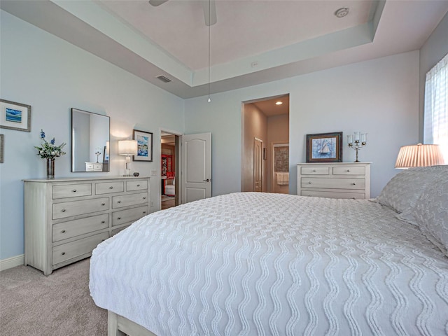 515 Sawgrass Bridge Rd, Venice, FL 34292 - bedroom featuring light carpet, baseboards, a tray ceiling, and ensuite bathroom