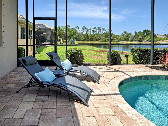 515 Sawgrass Bridge Rd, Venice, FL 34292 - view of swimming pool featuring a water view, a patio area, glass enclosure, and a lawn