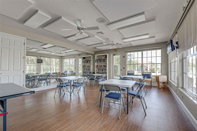 515 Sawgrass Bridge Rd, Venice, FL 34292 - dining area featuring a textured ceiling, a ceiling fan, wood finished floors, and baseboards