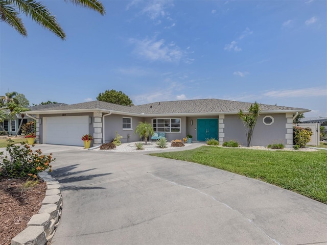 ranch-style house featuring stucco siding, driveway, a garage, and a front lawn