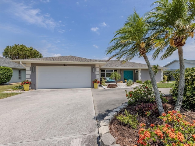ranch-style home featuring stucco siding, an attached garage, and concrete driveway