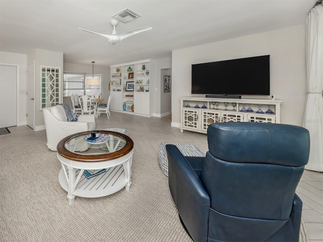 living room featuring ceiling fan and baseboards