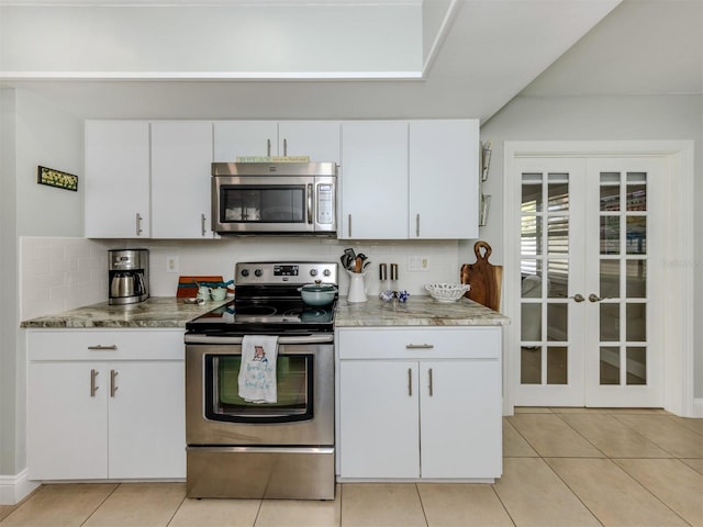 kitchen featuring appliances with stainless steel finishes, french doors, backsplash, and white cabinets