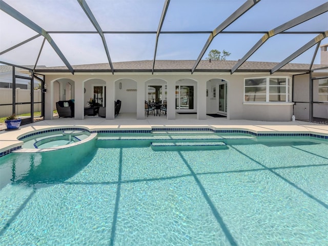 view of swimming pool featuring a patio area, a pool with connected hot tub, and a lanai