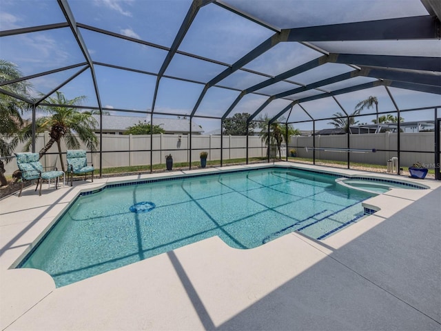 view of swimming pool featuring a patio area, a fenced backyard, a pool with connected hot tub, and glass enclosure