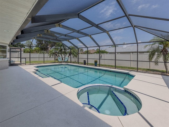 view of swimming pool with a pool with connected hot tub, a fenced backyard, and a patio