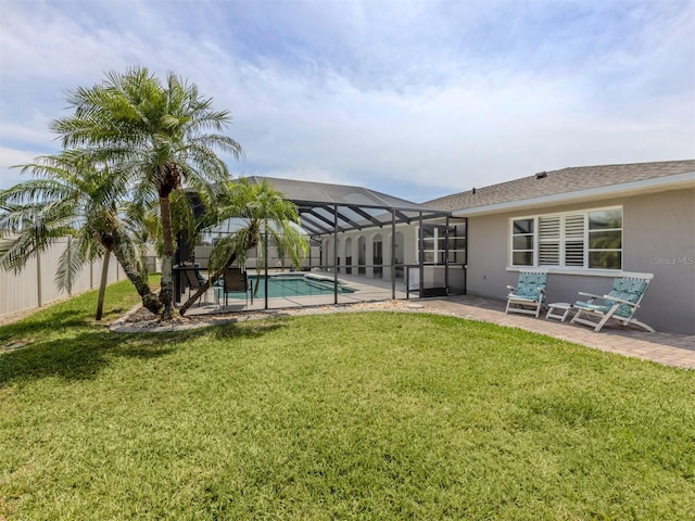 rear view of house with a patio, stucco siding, and a lanai
