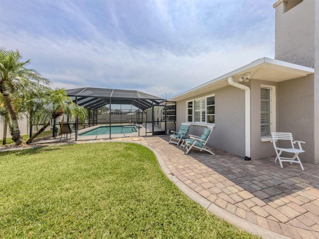view of pool featuring a patio area, a lawn, and glass enclosure
