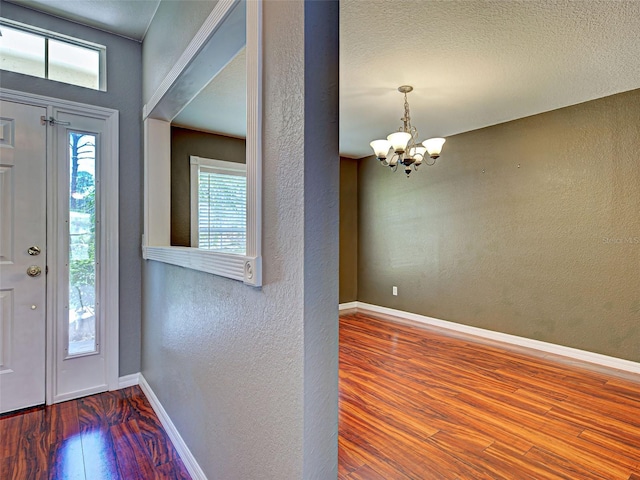 4103 Kinlock St, North Port, FL 34286 - foyer entrance featuring wood finished floors, a chandelier, and a textured wall