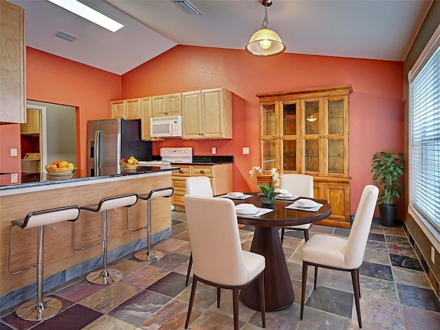 4103 Kinlock St, North Port, FL 34286 - dining area with vaulted ceiling, stone tile flooring, and washer / dryer