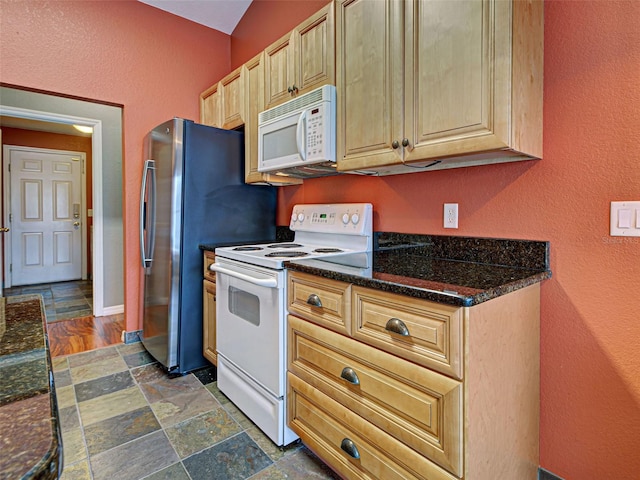 4103 Kinlock St, North Port, FL 34286 - kitchen featuring white appliances, dark stone finish flooring, a textured wall, and dark stone counters