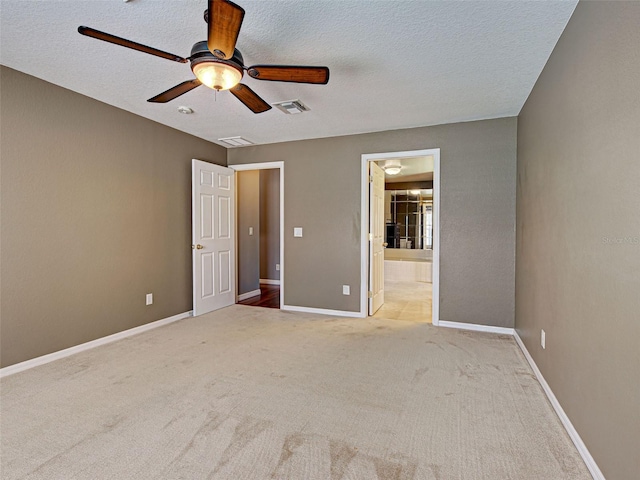 4103 Kinlock St, North Port, FL 34286 - unfurnished bedroom featuring carpet flooring, ensuite bath, a textured ceiling, and a ceiling fan