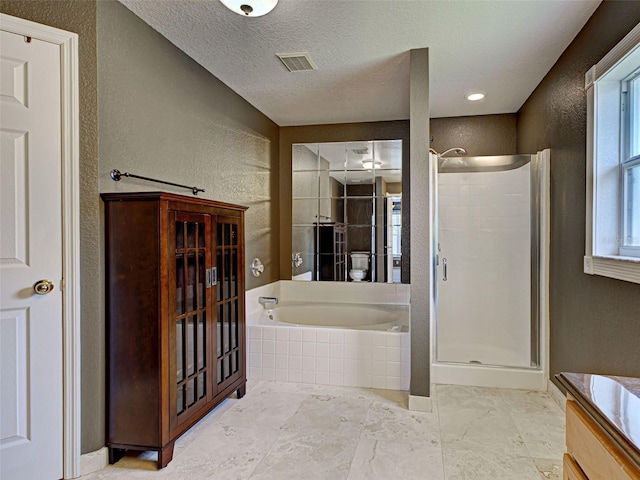 4103 Kinlock St, North Port, FL 34286 - full bathroom featuring a shower stall, a garden tub, a textured wall, vanity, and a textured ceiling