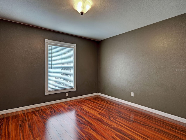 4103 Kinlock St, North Port, FL 34286 - spare room with wood finished floors and a textured wall