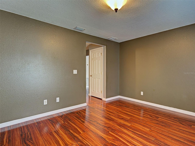 4103 Kinlock St, North Port, FL 34286 - unfurnished room with wood finished floors, a textured ceiling, and a textured wall