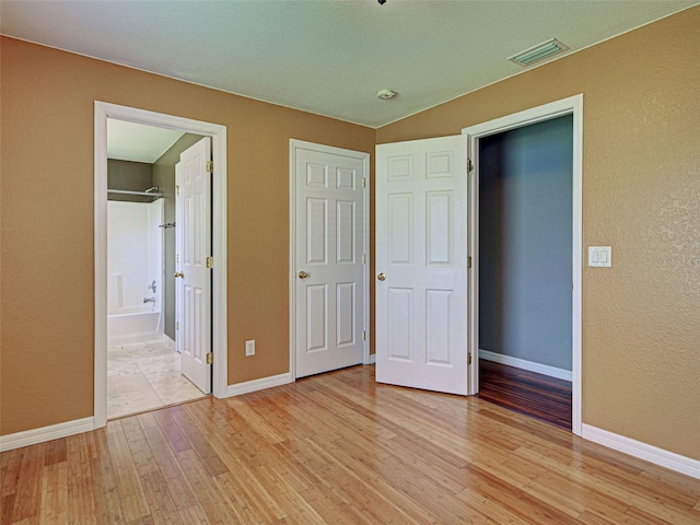 4103 Kinlock St, North Port, FL 34286 - unfurnished bedroom featuring light wood-type flooring and a textured wall