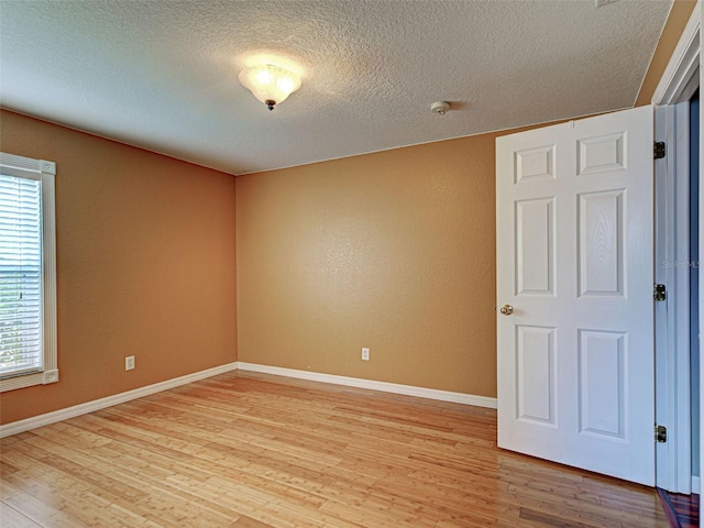4103 Kinlock St, North Port, FL 34286 - spare room with healthy amount of natural light, light wood-type flooring, a textured ceiling, and a smoke detector
