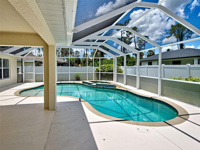 4103 Kinlock St, North Port, FL 34286 - view of swimming pool featuring a patio area, a fenced backyard, glass enclosure, and a pool with connected hot tub