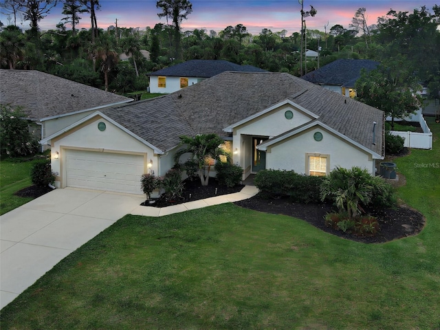 4103 Kinlock St, North Port, FL 34286 - ranch-style home featuring stucco siding, a garage, driveway, and roof with shingles
