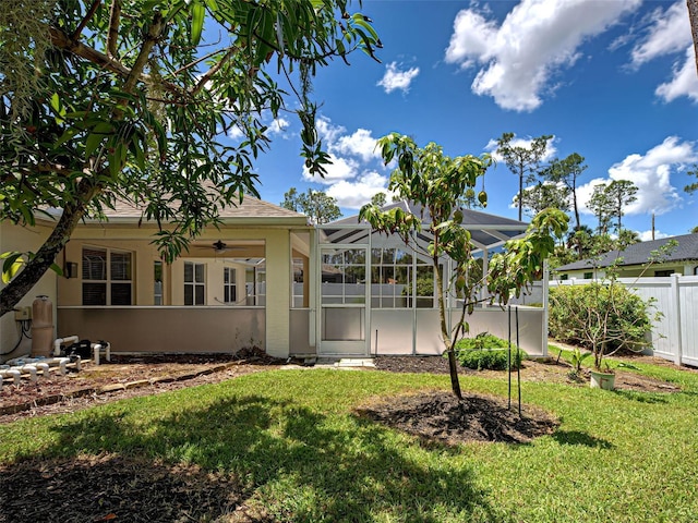 4103 Kinlock St, North Port, FL 34286 - back of house featuring stucco siding, ceiling fan, and glass enclosure