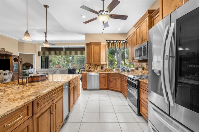 3950 Pepper Ln, North Port, FL 34287 - kitchen featuring appliances with stainless steel finishes, light tile patterned floors, brown cabinetry, open floor plan, and recessed lighting