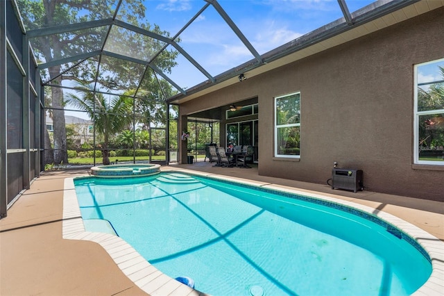 3950 Pepper Ln, North Port, FL 34287 - view of swimming pool featuring a patio area, ceiling fan, a pool with connected hot tub, and glass enclosure