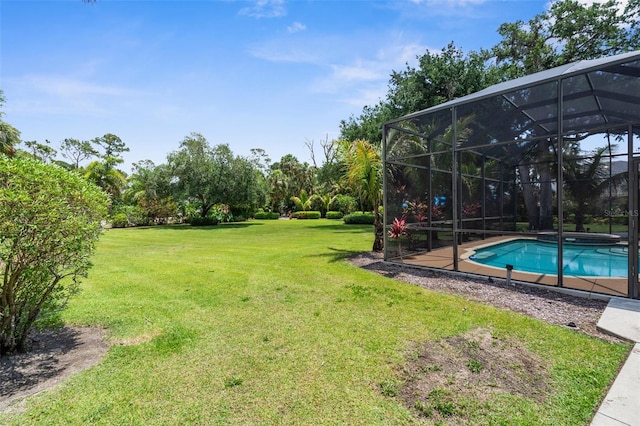 3950 Pepper Ln, North Port, FL 34287 - view of grassy yard with an outdoor pool and glass enclosure