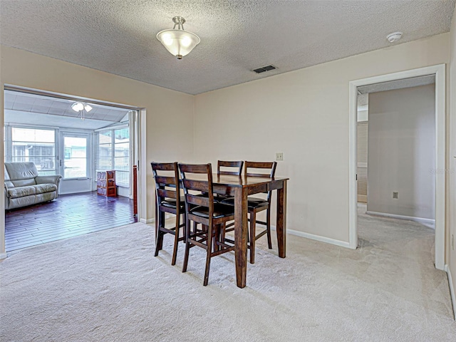 3141 Heron Shores Dr, Venice, FL 34293 - dining room featuring carpet floors and a textured ceiling