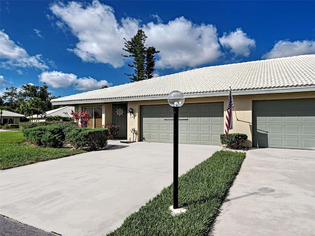3141 Heron Shores Dr, Venice, FL 34293 - ranch-style house with a tiled roof, stucco siding, an attached garage, and concrete driveway