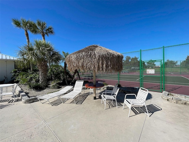 3141 Heron Shores Dr, Venice, FL 34293 - view of patio with a tennis court and a gate