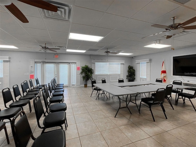 3141 Heron Shores Dr, Venice, FL 34293 - dining area with ceiling fan, a paneled ceiling, light tile patterned flooring, and healthy amount of natural light