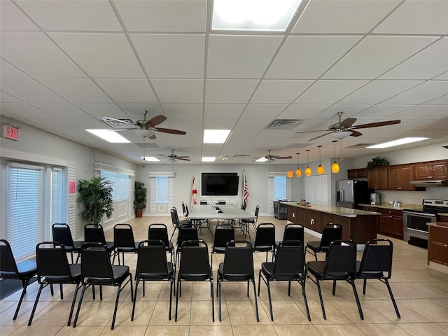 3141 Heron Shores Dr, Venice, FL 34293 - dining space with ceiling fan, a paneled ceiling, plenty of natural light, and light tile patterned floors