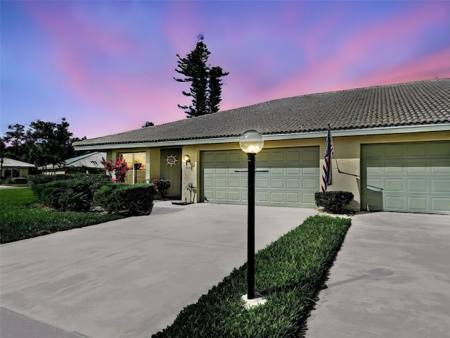 3141 Heron Shores Dr, Venice, FL 34293 - ranch-style house featuring driveway, stucco siding, a garage, and a tiled roof