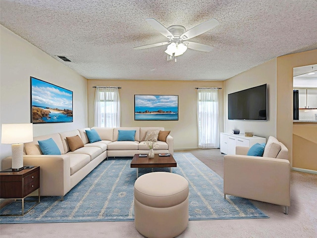 3141 Heron Shores Dr, Venice, FL 34293 - living room with healthy amount of natural light, a ceiling fan, a textured ceiling, and carpet