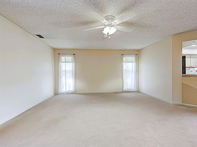 3141 Heron Shores Dr, Venice, FL 34293 - carpeted spare room with plenty of natural light, a ceiling fan, and a textured ceiling