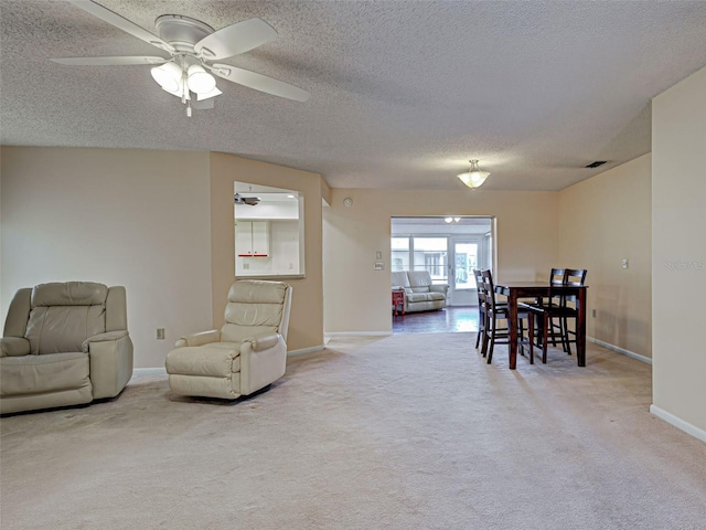 3141 Heron Shores Dr, Venice, FL 34293 - living room with carpet flooring, a ceiling fan, and a textured ceiling