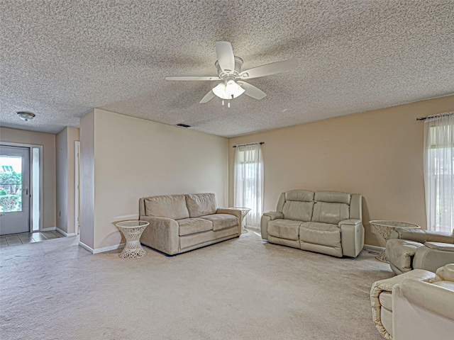 3141 Heron Shores Dr, Venice, FL 34293 - living area with carpet flooring, a textured ceiling, a ceiling fan, and plenty of natural light