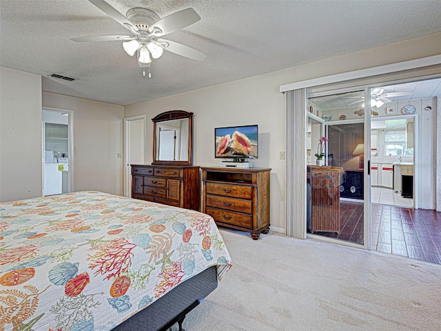 3141 Heron Shores Dr, Venice, FL 34293 - carpeted bedroom featuring a textured ceiling, ceiling fan, and washer and clothes dryer