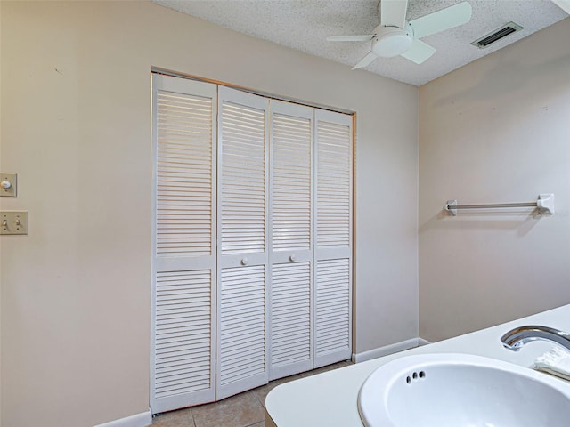 3141 Heron Shores Dr, Venice, FL 34293 - bathroom with a ceiling fan, tile patterned floors, a closet, and a textured ceiling
