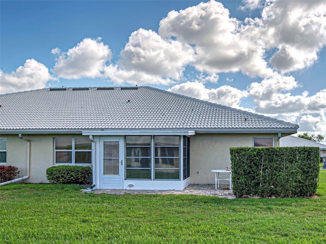 3141 Heron Shores Dr, Venice, FL 34293 - back of property with stucco siding, a tile roof, and a yard