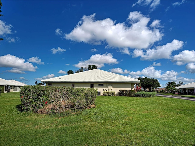3141 Heron Shores Dr, Venice, FL 34293 - view of property exterior with stucco siding, a lawn, and a tile roof