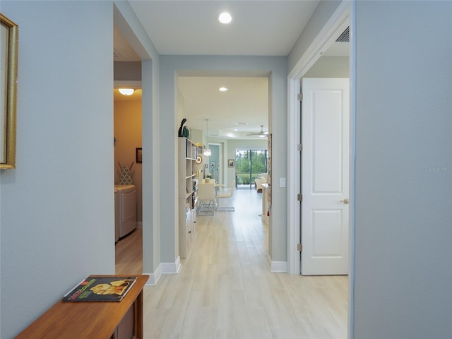 249 Tracino Ter, Nokomis, FL 34275 - hall with washing machine and clothes dryer, light wood-style floors, baseboards, and recessed lighting