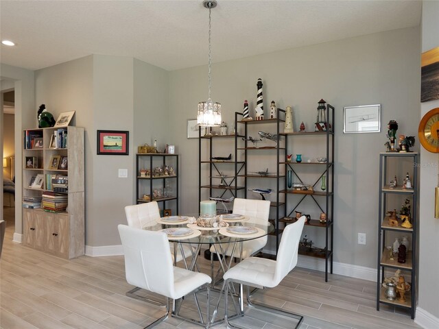249 Tracino Ter, Nokomis, FL 34275 - dining area featuring wood tiled floors, baseboards, a chandelier, and recessed lighting