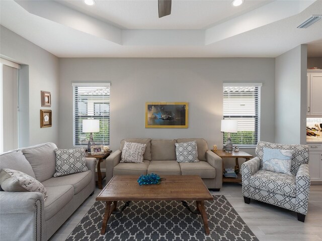 249 Tracino Ter, Nokomis, FL 34275 - living room with plenty of natural light, a tray ceiling, light wood-style floors, a ceiling fan, and recessed lighting